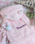 Personalised pink dressing gown robe with cute ears - worn by a baby.