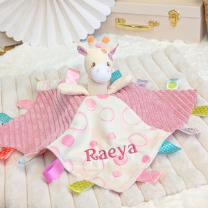Personalised baby comforter, pink with sensory ribbons and attached giraffe toy embroidered with the name Raeya