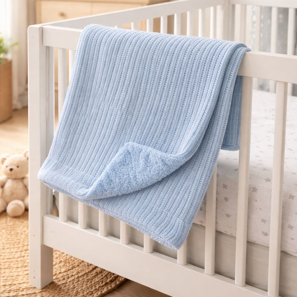 A blue knit cellular baby blanket with a sherpa back and can be personalised