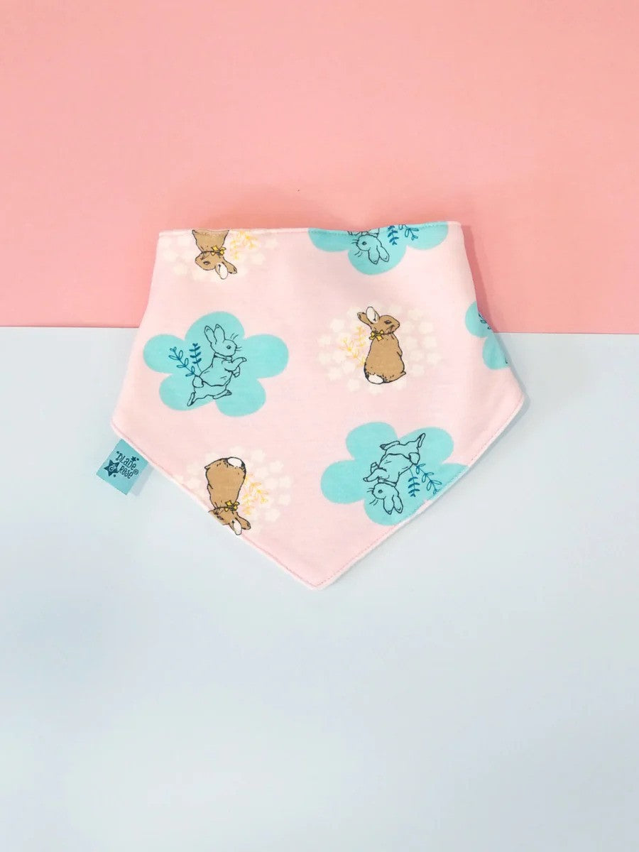 Pink bandana bib with Peter Rabbit design and teal accents