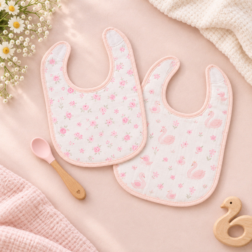 Pink baby feeding set with two bandana bibs and a spoon