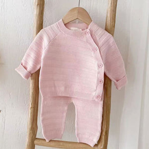 Pink baby girl clothing set in striped knitted baby clothes design with button fastening top and matching trousers.