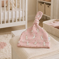 Pink knot hat with a pattern of cute white bunnies