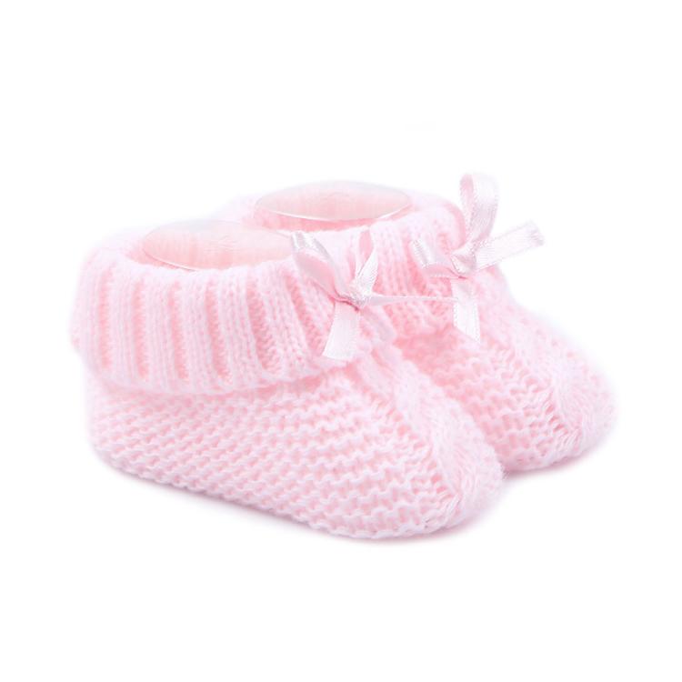 Pink knitted baby booties with bow
