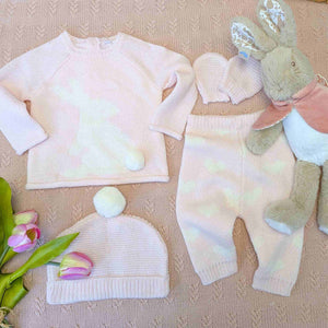 Pint knit baby girl clothing set with a bunny and pompom theme.