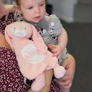A pink bunny soft toy with teething silicone.