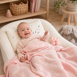 A pink cotton cellular baby blanket