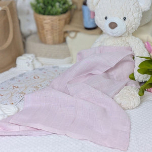 A pink 100% cotton muslin wrap for a baby.