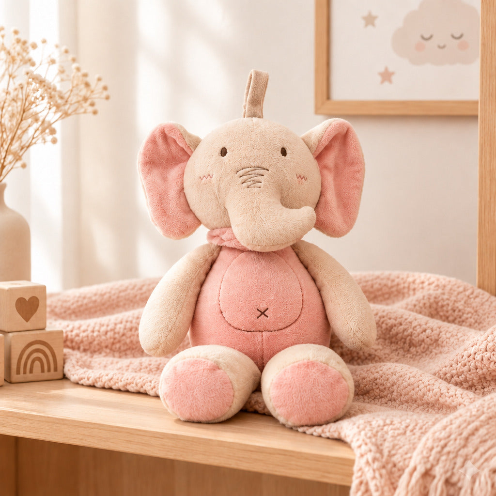 Pink and cream elephant soft toy with large pink ears, curved trunk and a loop on top