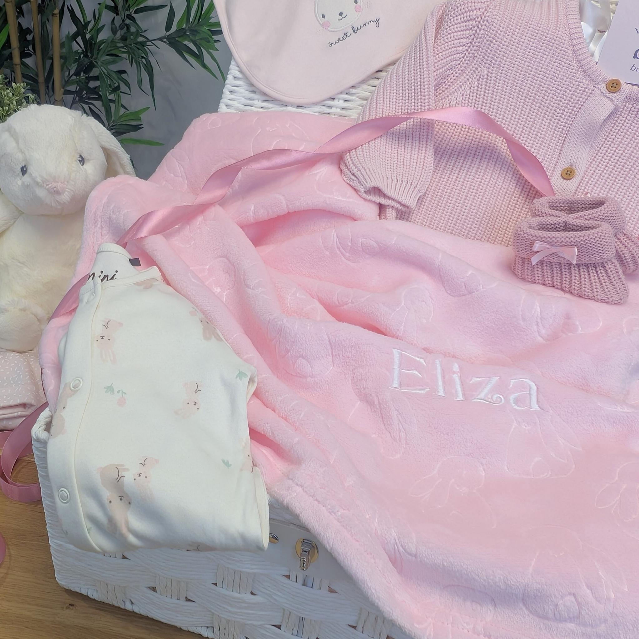 Pink baby blanket with embossed animals and can be personalised.