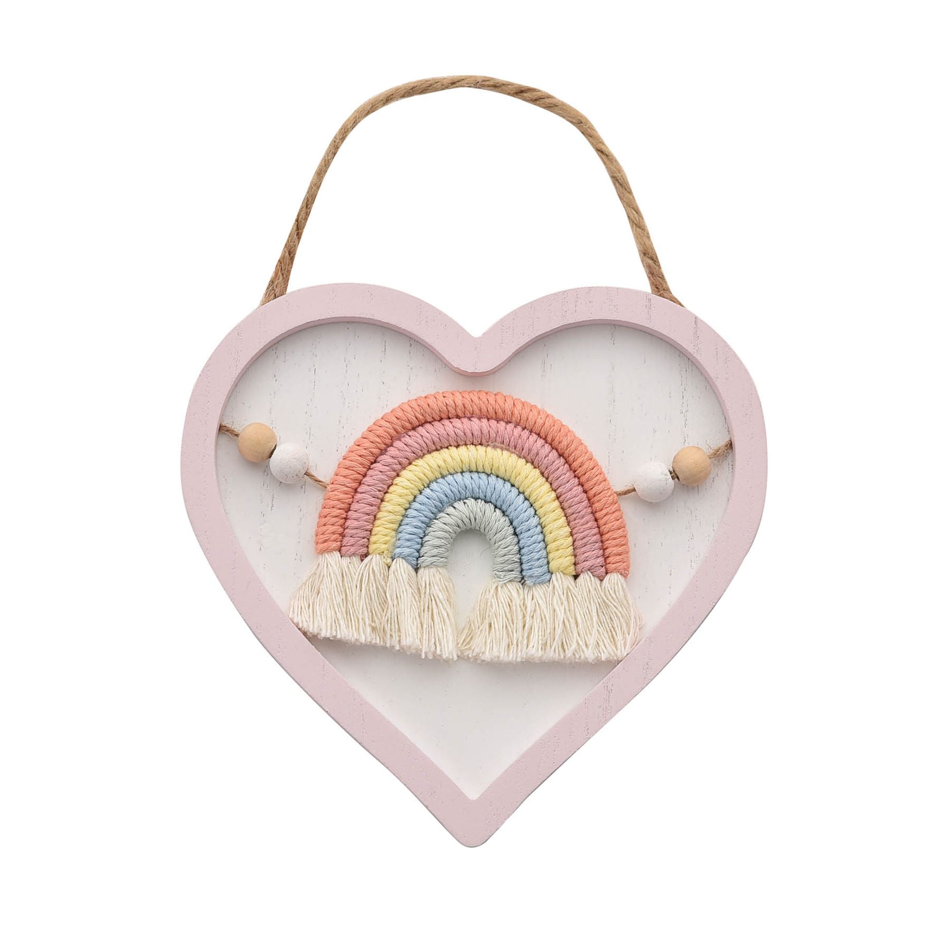 A hanging plaque in the shape of a heart with a pink outer, a white insert and a macrame rainbow in the middle