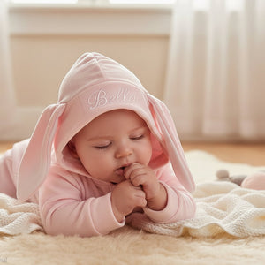 pink hooded baby outfit with stitched bunny ears and full length zip. Soft baby clothes for cosy newborn comfort.