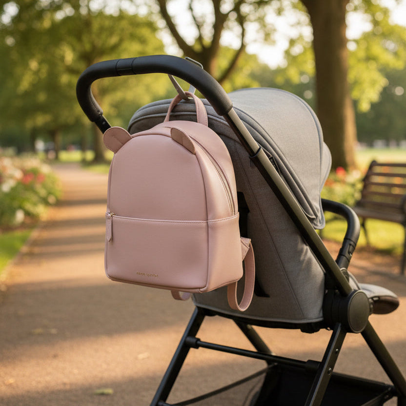 Pink children's backpack with curved top zip fastening and ears designed by Katie Loxton