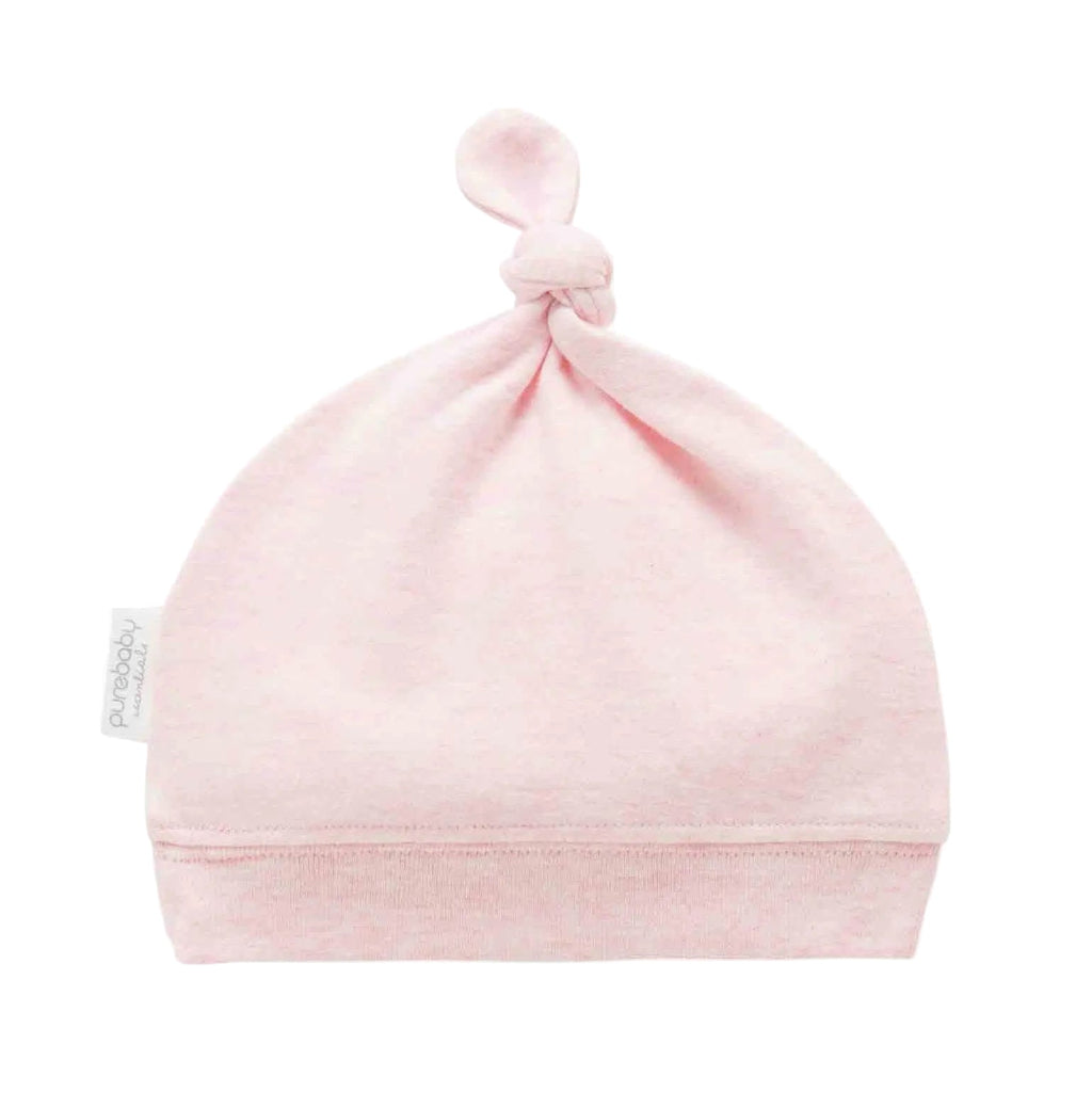 Pink organic cotton baby knot hat with soft ribbed band and adjustable top knot designed for comfortable newborn baby clothes.