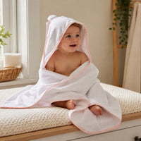 A pink and whte hooded towel with little bear ears which can be personalised with a name of choice