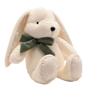 Angled seated view of plush bunny with green neck bow
