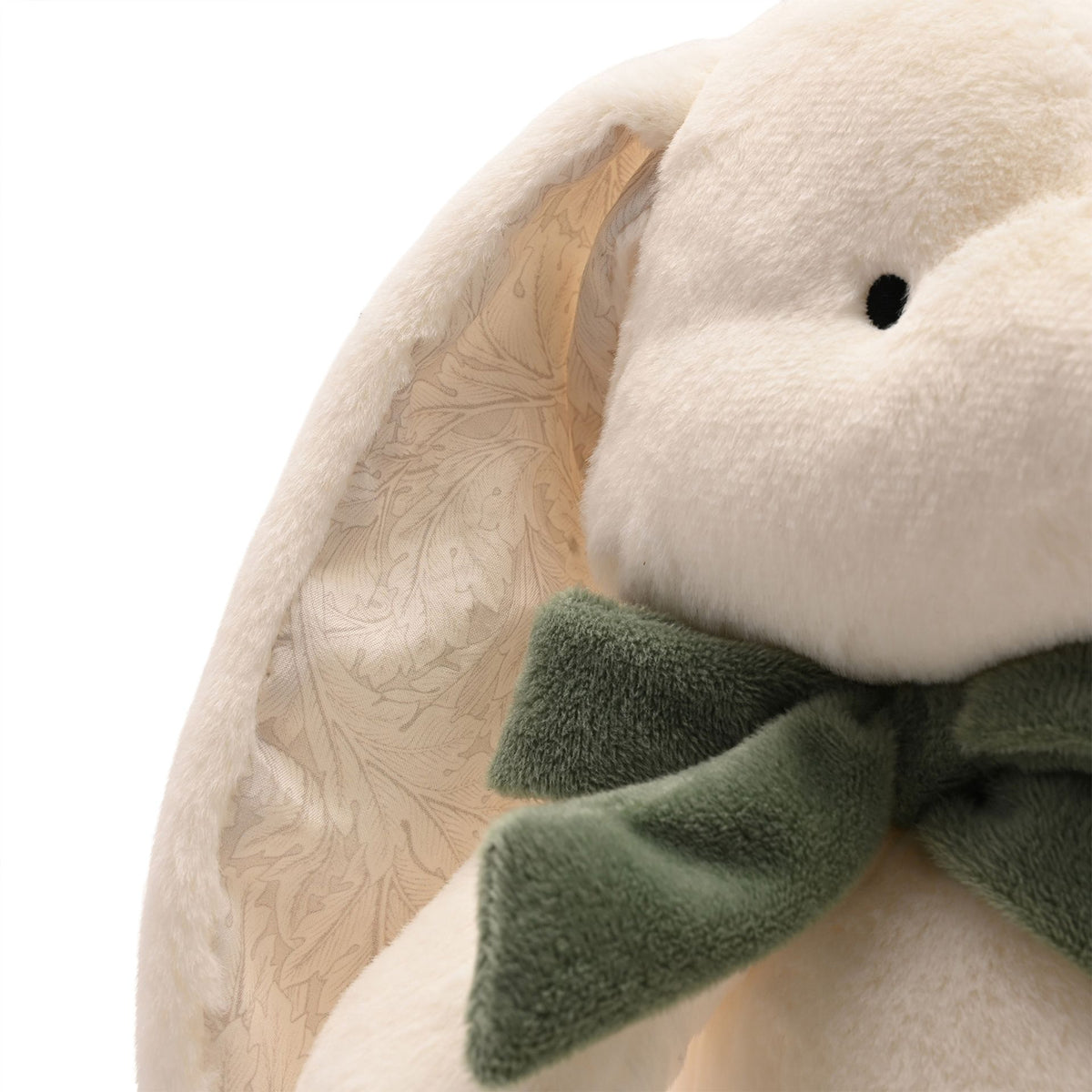 Close-up of bunny face, patterned inner ear and green fabric bow