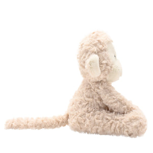 Side view of soft plush monkey toy with long tail