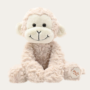 Front view of light brown plush monkey soft toy sitting upright