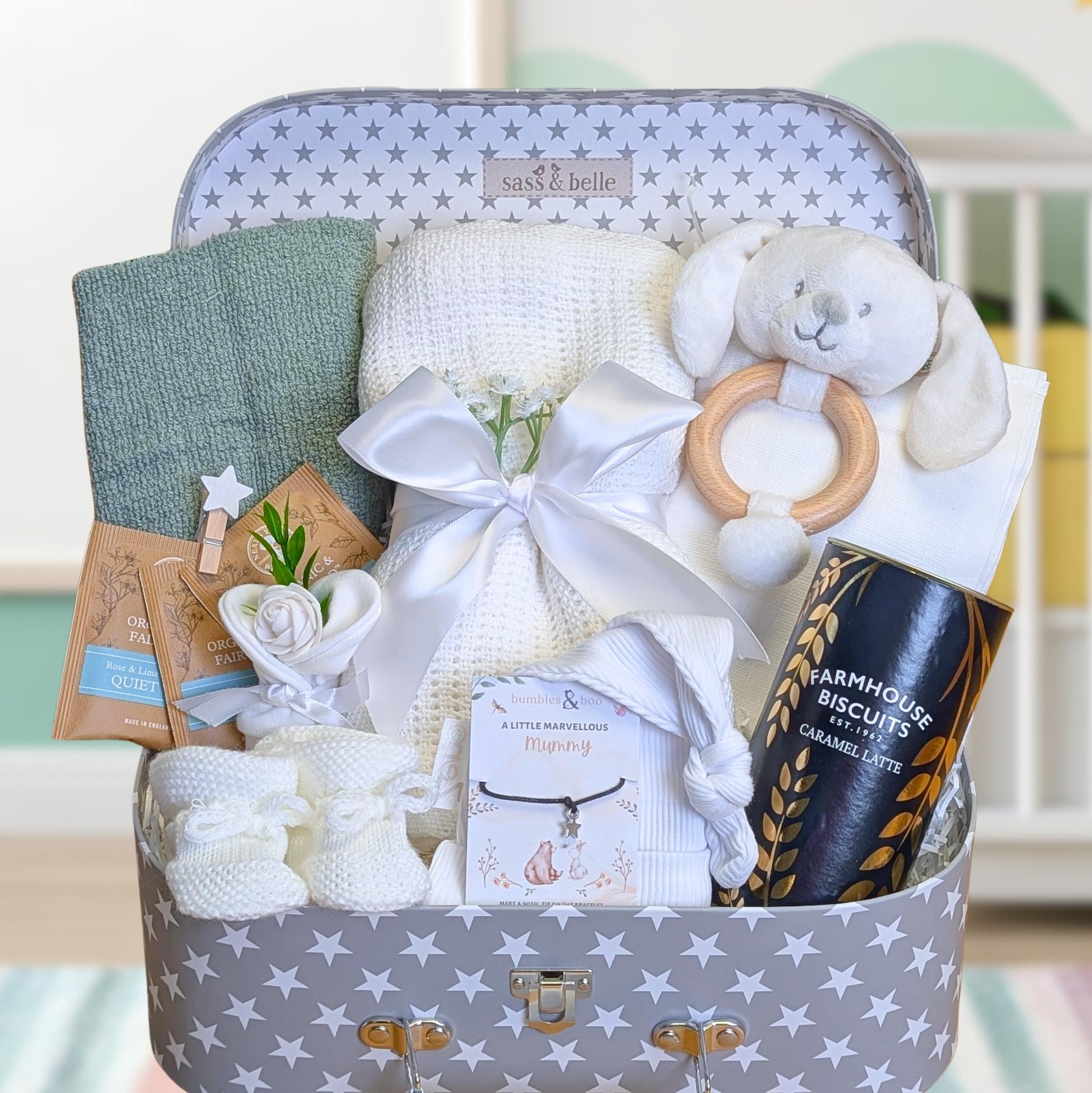 Pregnancy gifts in a gifts hamper with biscuits for mum and organic tea plus baby essentials.