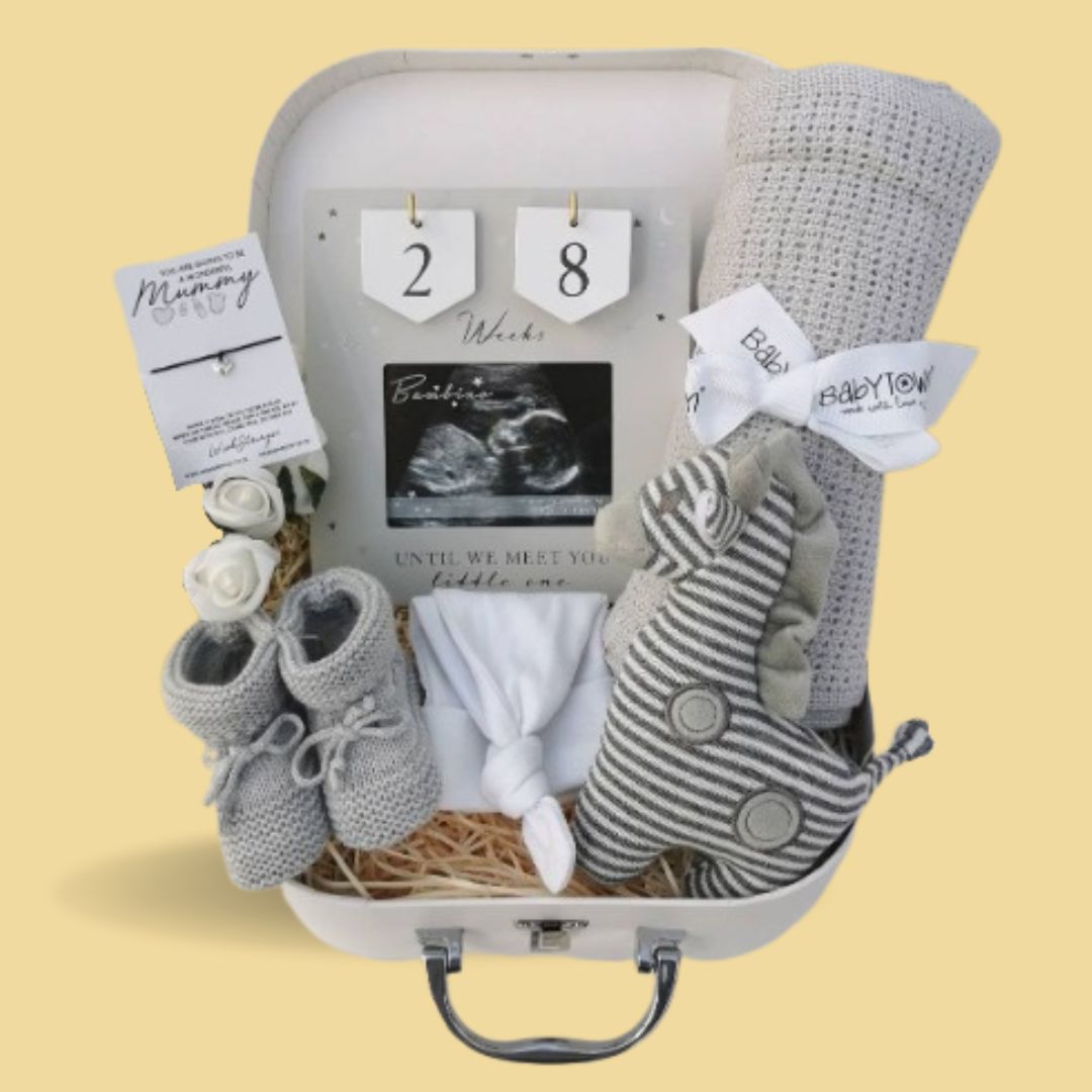 Pregnancy gifts in a hamper with countdown frame.