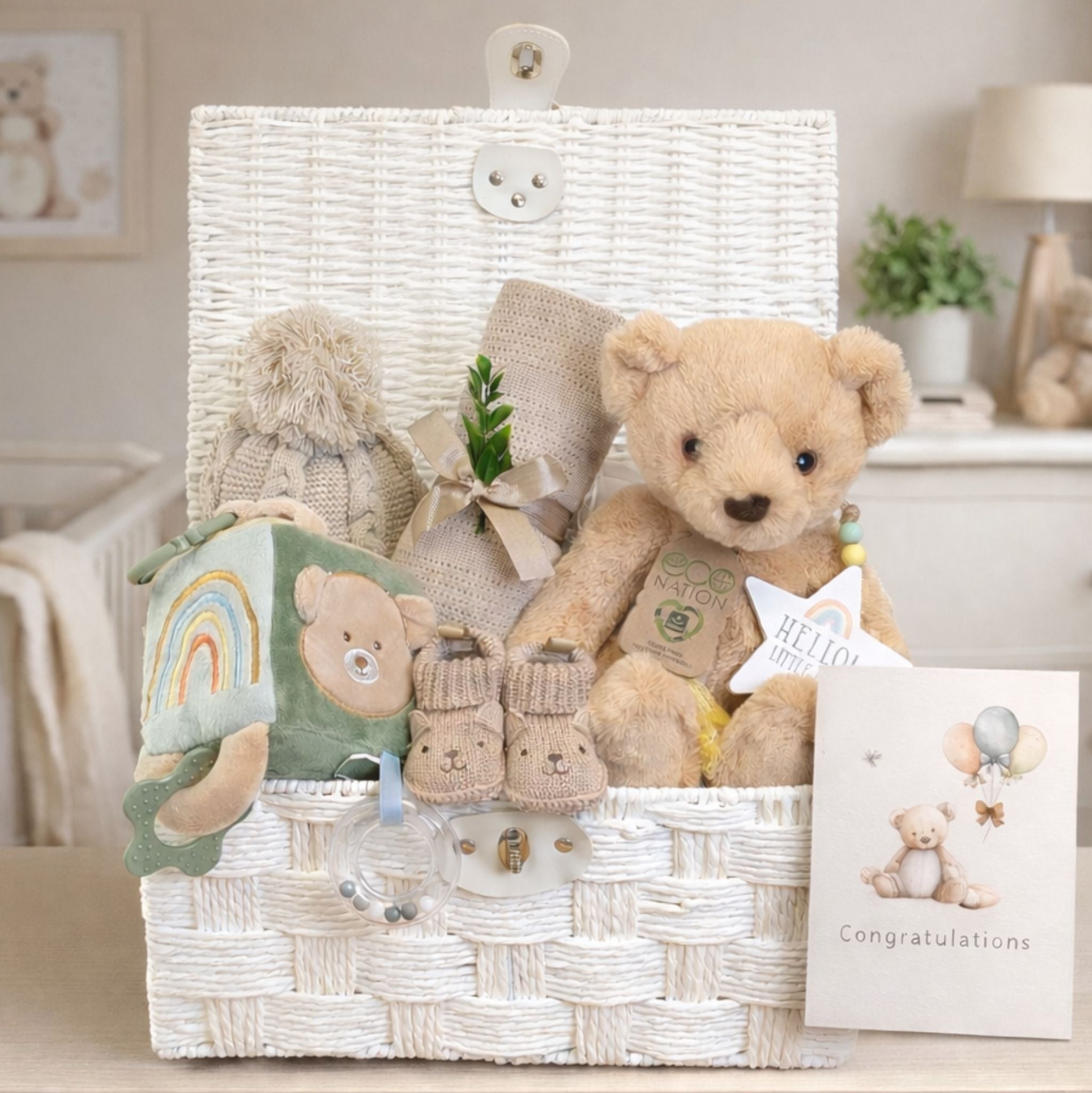 Newborn baby gifts hamper with teddy bear and soft blanket, perfect as a gift for new baby.