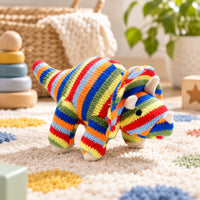 Colourful dinosaur baby rattle with red, orange, green and blue stripes in the shape of a Triceratops