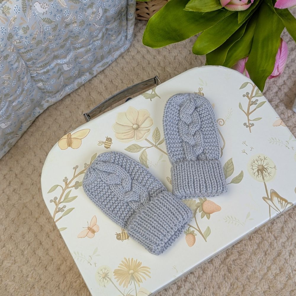 Pair of grey knit baby mittens made from recycled materials.