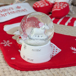 Snow globe with a rocking horse for Christmas.