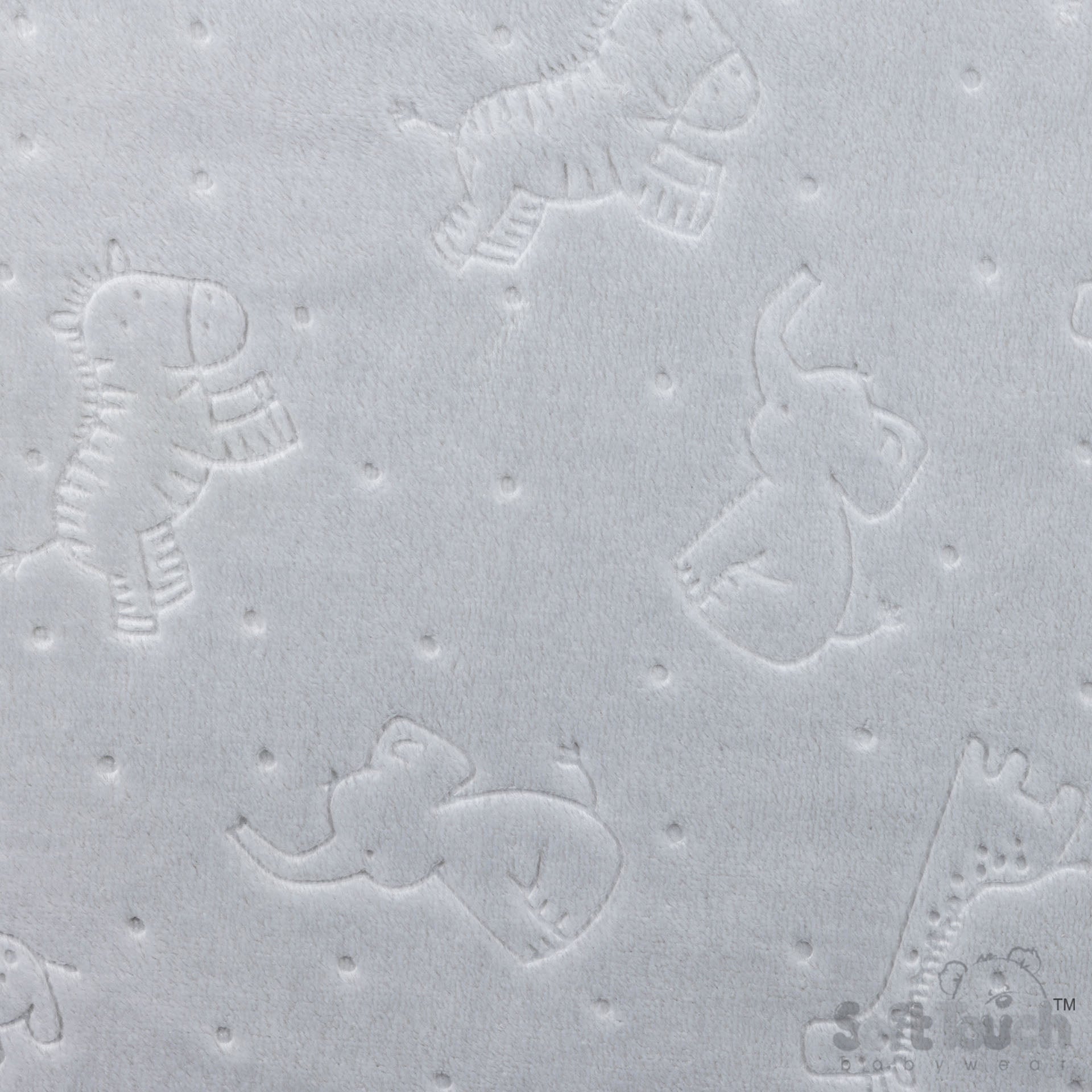 Textured surface with embossed animal shapes on a light gray background