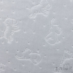 Textured surface with embossed animal shapes on a light gray background