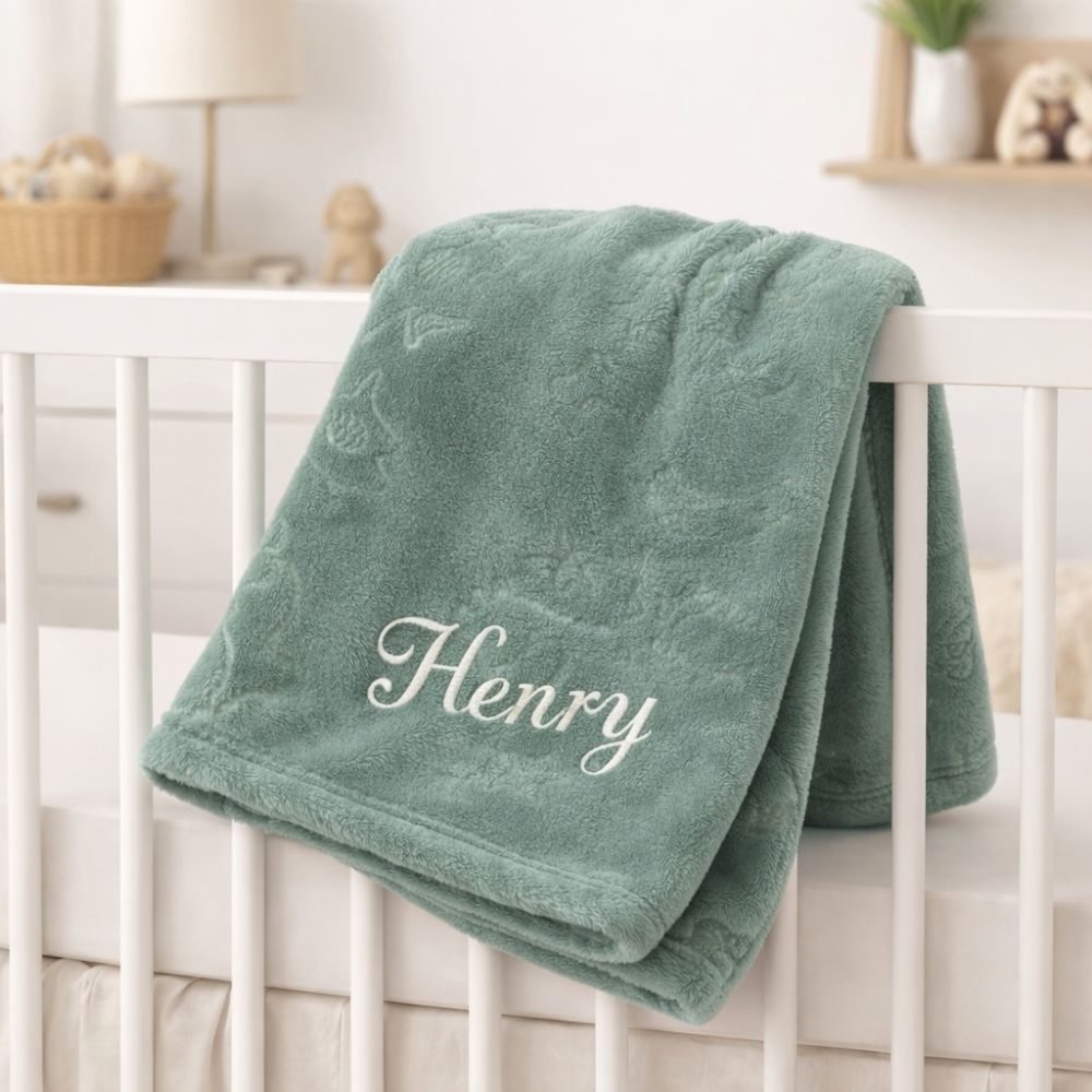 A sage green animal embossed fleece baby blanket