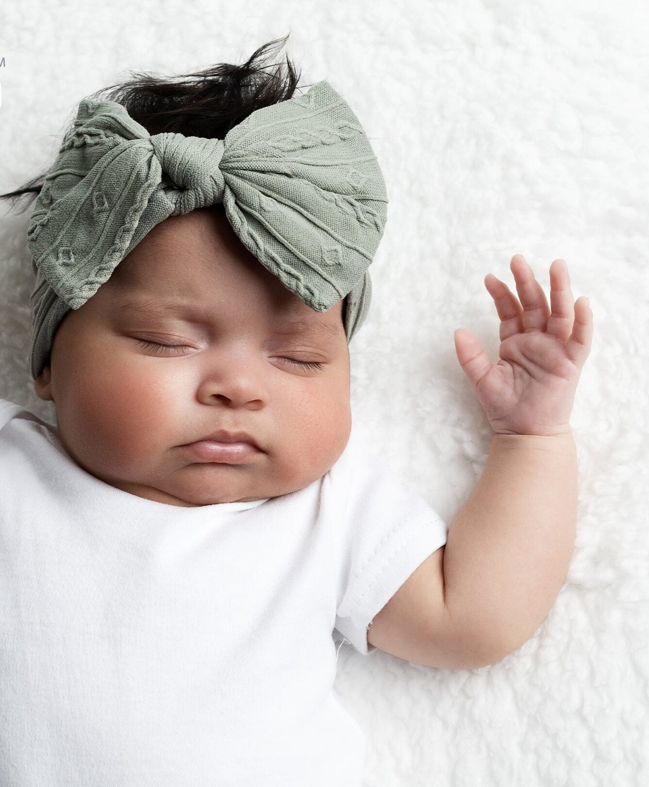Soft sage green baby headband with cable knit design and bow