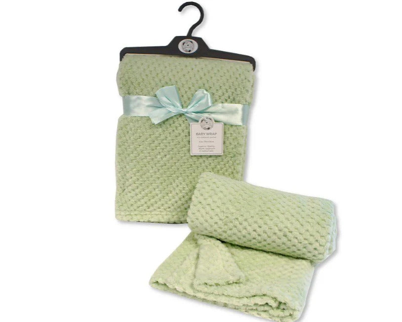 Plain sage green waffle baby wrap shown on a hanger with a ribbon, alongside a rolled blanket view.