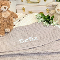 Sand coloured baby blanket in soft cotton which can be personalised.