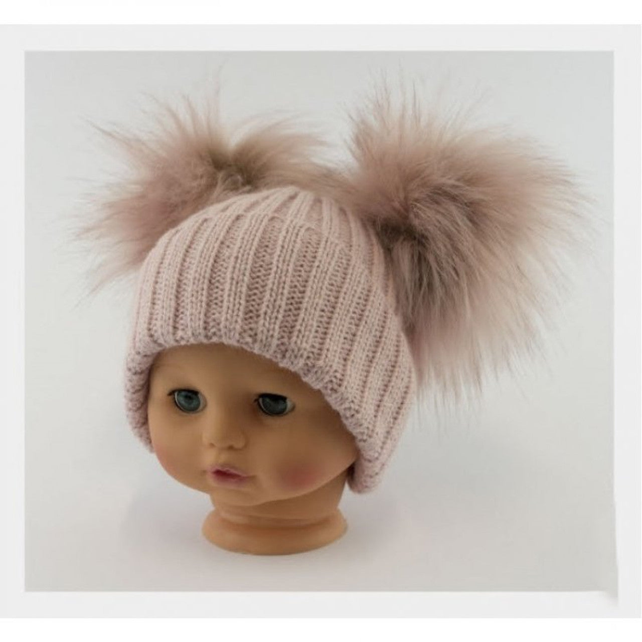 Pink knit hat with two pom-poms