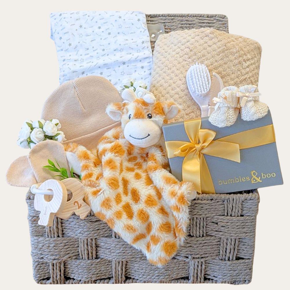 Baby hamper basket with gifts including plush giraffe and chocolates for the new parents.