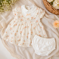 Baby girl clothing outfit of a dress and under pants.  In Beige with a floral pattern