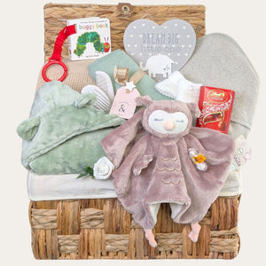 Baby gifts in a hamper with Steiff owl comforter and essential new baby gifts – perfect for a thoughtful present.