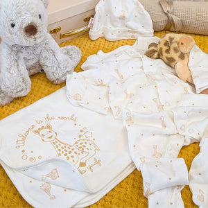 Baby clothing gift set with sophie la girafe blanket, sleepsuit and hat.