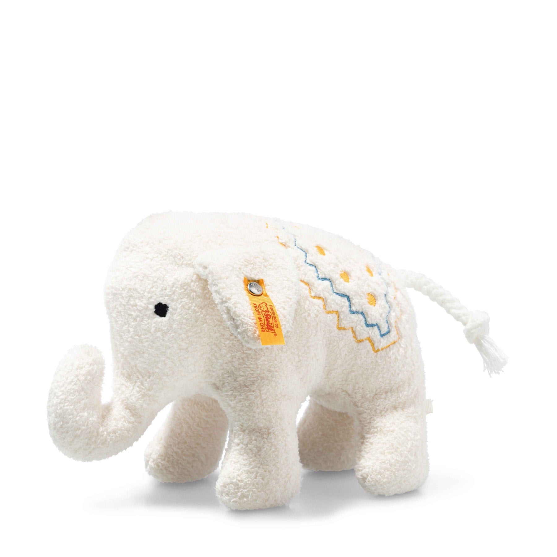 Cream elephant soft toy with yellow and blue embroidery details and a yellow Steiff tag attached to the ear