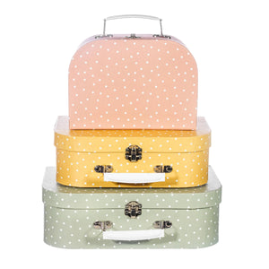 Three polka dot storage suitcases stacked with green on the bottom, yellow in the middle and pink/orange on the top.