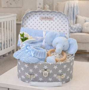 Blue baby gift box with elephant rattle and baby essential. Sweet present for a new baby boy.