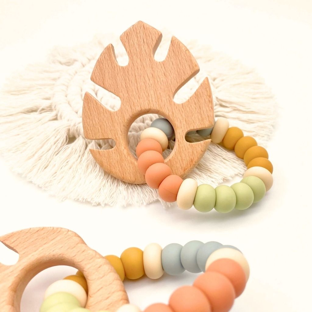 Wood and silicon baby teething toy in a tropical design with earthy colours. Non-toxic, eco friendly, suitable from birth. 