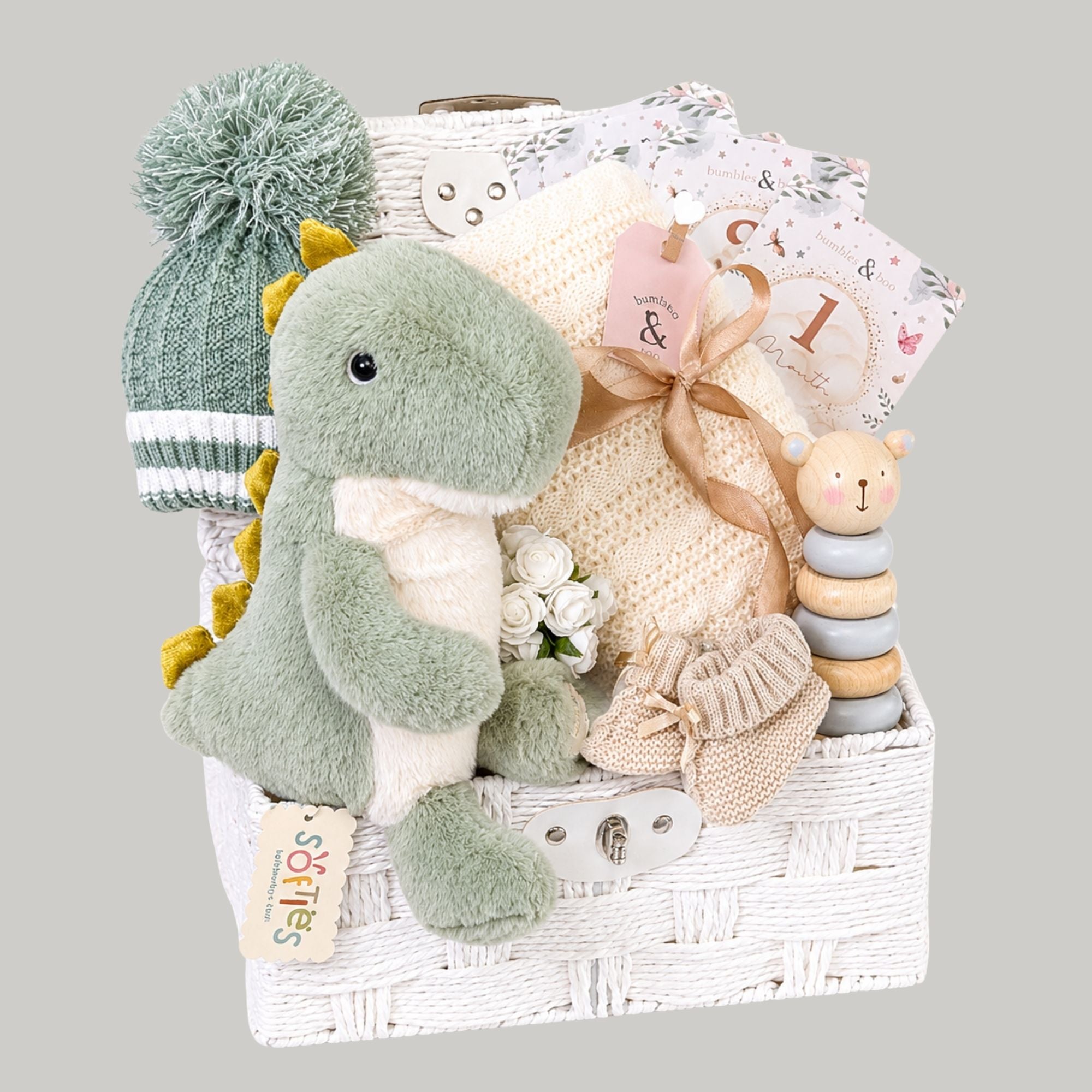 Luxury baby boy gifts hamper featuring a soft T-Rex plush toy and presents packed in a gift basket.