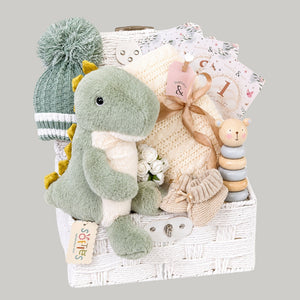 Luxury baby boy gifts hamper featuring a soft T-Rex plush toy and presents packed in a gift basket.