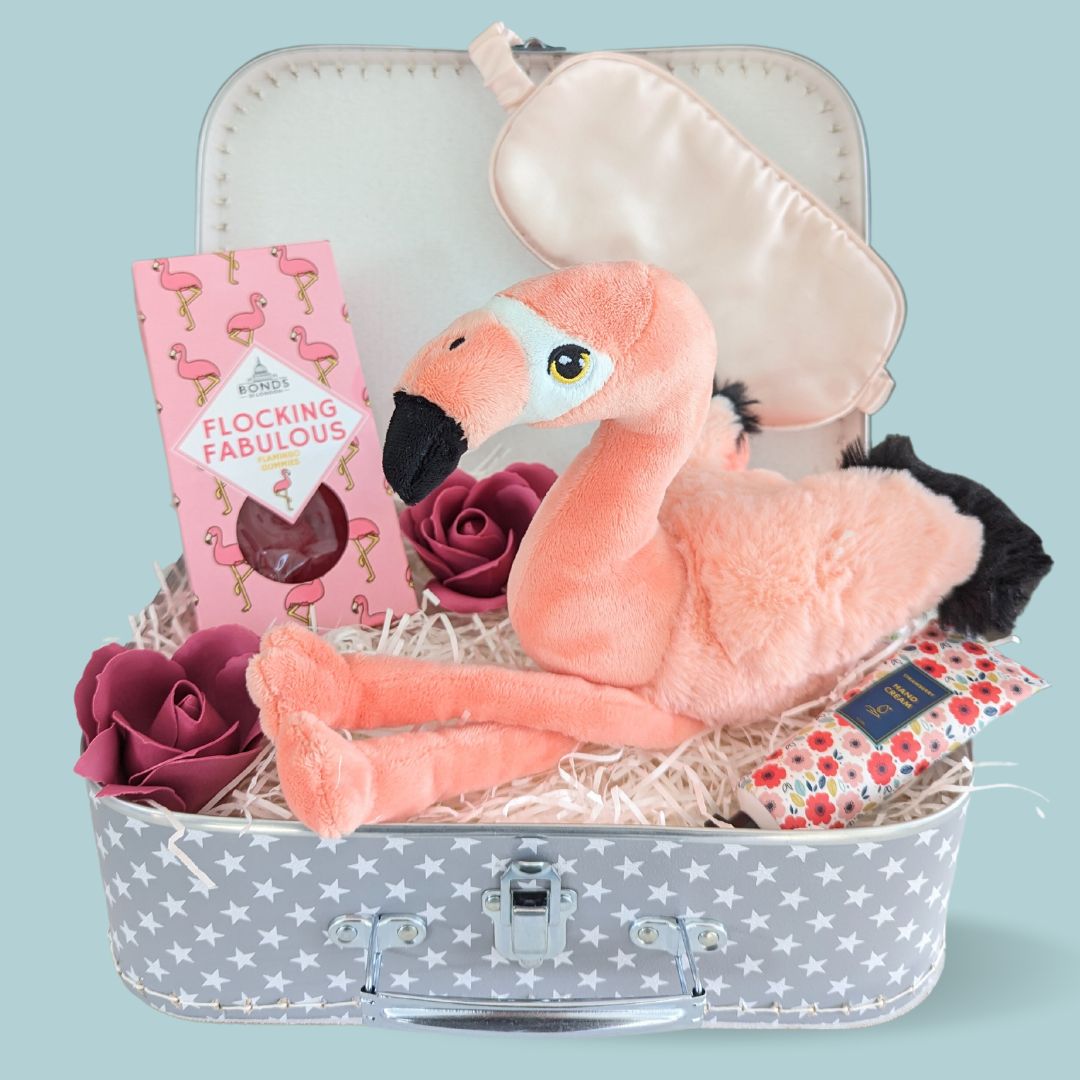 Treat trunk filled with flamingo sweets, flamingo soft toy, eye mask, hand cream and soap roses.