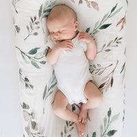 Bamboo swaddle blanket with leaf print pattern for a baby.