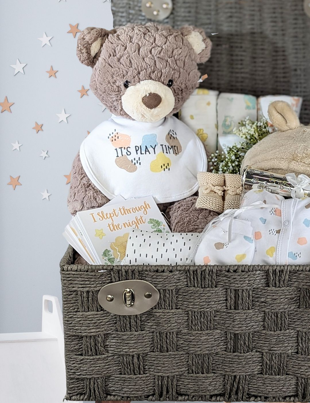 Large teddy bear baby basket with bear, silver plated birth certificate holder, baby clothing set, baby booties, blanket and muslin squares. 