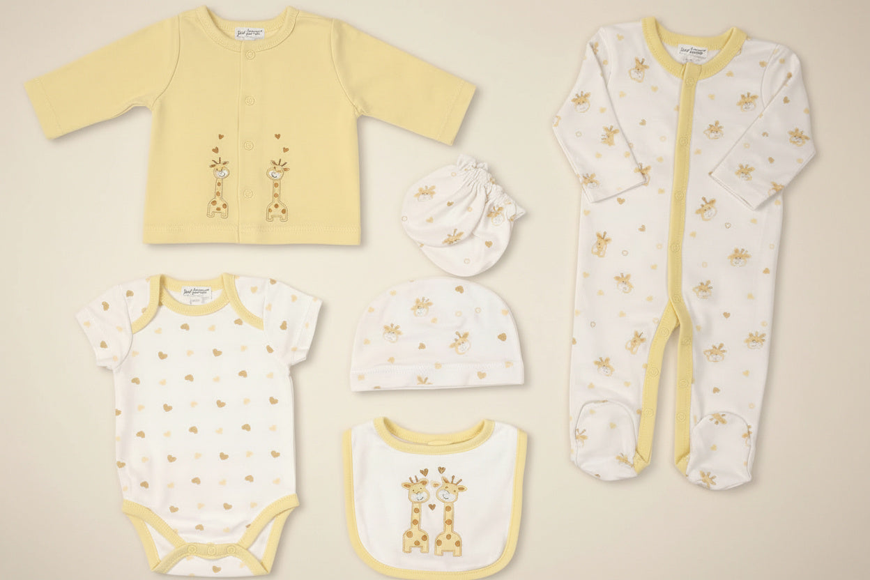 yellow and white baby clothing set with giraffe print

